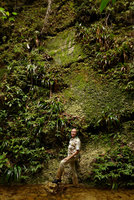 Patrick Blanc at the base of a vertical seeping rock mostly covered by Xyris grandis, Selaginella stipulata and Camptandra parvula, Harau valley, West Sumatra, Dec. 2016