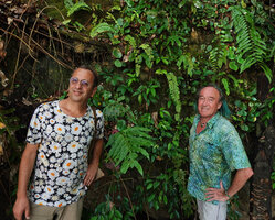 Pascal Heni and Patrick Blanc in front of a vertical limestone cliff mostly covered by Begonia gueritziana and ferns, Sukau, Kinabatangan, Sabah, Borneo, July 2022