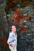 Patrick Blanc and a bright red saxicolous lichen, La Farola, Baracoa, Cuba, Feb. 2017