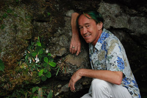 Patrick Blanc and a flowering population of Codonoboea bakoensis growing on a vertical sandstone shaded rock, Bako, Sarawak, Borneo, July 2010