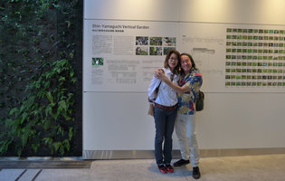 Patrick Blanc and Atsuko in front of the explanatory billboard of the Vertical Garden at the new Shinkansen station walkway, Yamaguchi, Japan, Oct. 2015