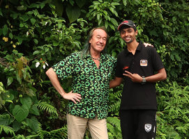Patrick Blanc and his guide Vishnu with a blooming Mussaenda in shola forest, Maragunda, Karnataka, India, June 2018