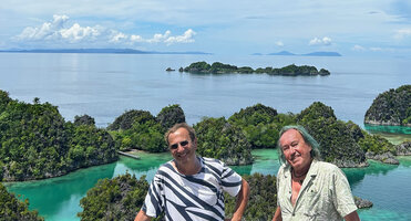 Patrick Blanc and Pascal Héni in front of the Fam islands, karst outcrops covered by forest with some Hydriastele procera on the ridge tops, Raja Ampat, West Papua, May 2025