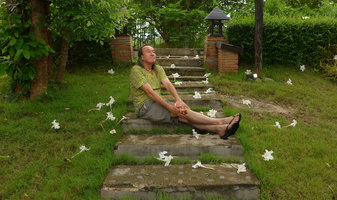 Patrick Blanc at early morning sitting among the fallen night blooming flowers of Dolichandrone falcata, Dan Sai, Thailand, June 2016
