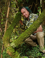 Patrick Blanc between two mossy branches, Hang Cop Waterfall, Dalat, Vietnam, Nov. 2019