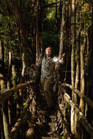Patrick Blanc crossing a forest stream on a traditional wooden and rattan bridge, Tari, 2000 m asl, Hela, Papua New Guinea, March 2016