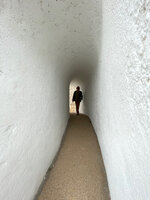 Patrick Blanc entering a pedestrian tunnel along the sea shore, Cap d&#039;Ail, France, Nov. 2021