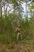 Patrick Blanc holding the greyish stems of a bamboo, probably Vietnamosasa ciliata, growing on old sandstone slope, Dan Sai, Thailand, June 2016