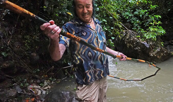Patrick Blanc holding the main climbing stem of a Dinochloa, Taptap, Cebu, Philippines, Dec. 2024