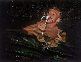 Patrick Blanc immersed in a forest stream to test the Crinum natans perfume, Campo, Cameroun, Oct. 1991