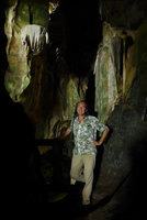 Patrick Blanc in a cave with rocks covered by blue green Cyanobacteria due to some faint penetration of light, Payakumbuh, West Sumatra, Dec. 2016