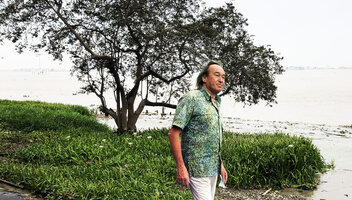Patrick Blanc in front of a flowering population of Crinum erubescens emersed at low tide along the Rio Guayas banks, Guayaquil, Ecuador, Aug. 2021