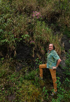 Patrick Blanc in front of a permanently seeping vertical rock face covered by the bright pink Sonerila  nemakadensis and Impatiens henslowiana, Munnar, 1800 m asl, Kerala, India, Jan. 2023