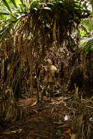 Patrick Blanc in muddy varzea forest among dead Heliconia leaves, Iquitos, Peru, Aug 2014