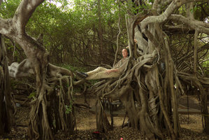 Patrick Blanc laying on the root system of the famous banyan Ficus benjamina, Phimai, Thailand, June 2016