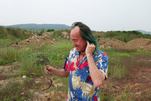 Patrick Blanc looking at a sapling of Albizia julibrissin, Qingdao, China, July 2015