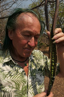 Patrick Blanc looking a the long open seed pod of Cassia abbreviata,  Nsumbu NP, Tanganyika lake, Zambia, Sept. 2017