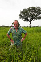 Patrick Blanc looking at the flowering Eulophia cucullata, Katavi NP, Tanzania, Jan. 2021