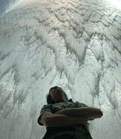 Patrick Blanc looking at the water flowing on the methacrylate transparent wall of the waterfall at the Jewel, Changi airport, Singapore, June 2019
