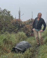 Patrick Blanc meeting a giant tortoise, Chelonoidis porteri in the highlands by a rainy day, El Puntudo, Santa Cruz, Galapagos, Aug. 2021