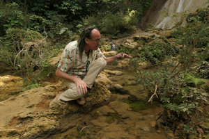 Patrick Blanc observing the flower of Ginoria americana, a rheophytic shrub, El Nicho, Cienfuegos, Cuba, Feb.2017
