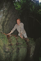 Patrick Blanc on a rock covered by some Ludisia discolor growing on the bare vertical rocky surface, Kelantan, Malaysia, Aug. 2003
