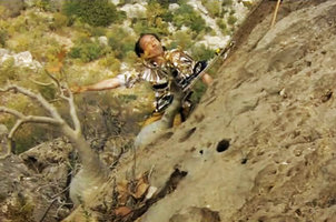 Patrick Blanc  on a vertical cliff to observe a Dorstenia gigas population, Socotra, March 2005