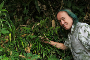 Patrick Blanc showing an Ophiopogon species with wide linear leaves, Nam Ta waterfall, Ba Be, Vietnam, Nov. 2017
