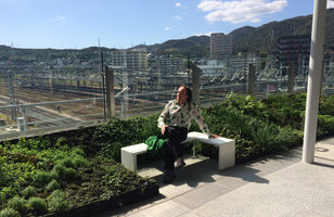 Patrick Blanc sitting on a bench of the walkway smooth Vertical Garden,  Shinkansen Yamaguchi station, Japan, Oct. 2015