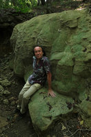 Patrick Blanc sitting on a dry travertine riverbed encrusted by green algae and other plant fragments, Pacitan, Java, May 2018