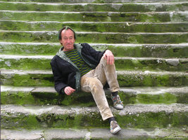 Patrick Blanc sitting on stairs covered by green algae, Marseille, France, Feb 2010
