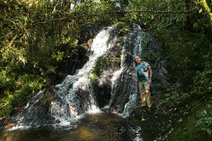 Patrick Blanc totally wet but happy to have reached a small shaded waterfall whose rocks are covered by the rheophytic Acorus gramineus, Thac Tinh Yeu, Sapa, Vietnam, Nov. 2017
