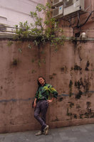 Patrick Blanc under Boehmeria penduliflora var.loochooensis installed in the crack of an old wall, Hong Kong, April 2016