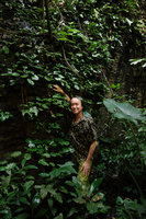 Patrick Blanc in front a a healthy population of the rare Paraboea vulpina covering a deeply shaded vertical limestone cliff, Perak, Malaysia, June 2015
